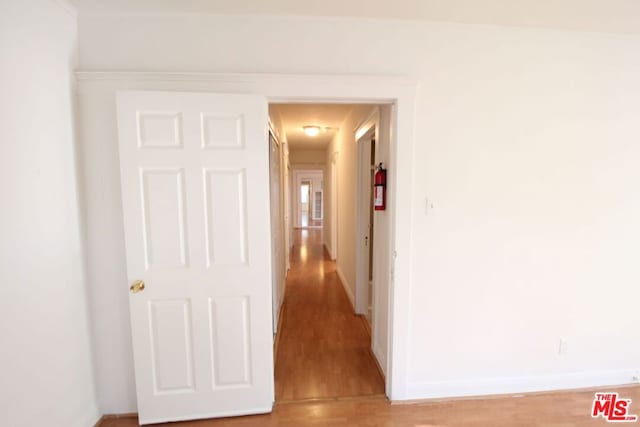 hall with wood-type flooring