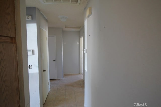 corridor with light tile patterned floors