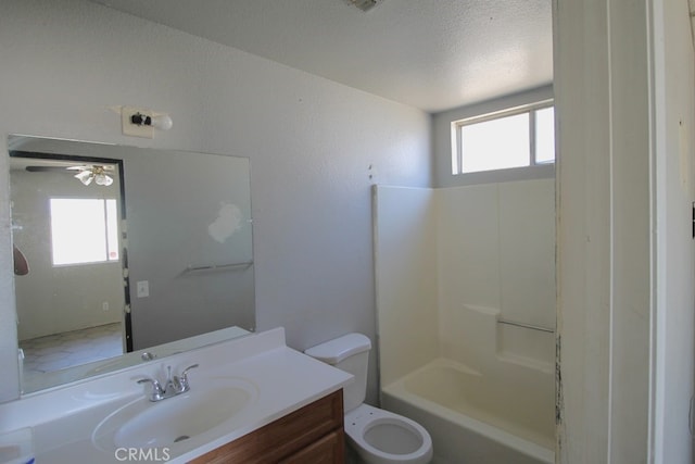 full bathroom featuring shower / tub combination, a healthy amount of sunlight, vanity, and toilet