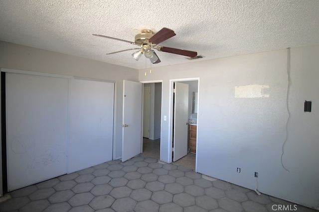 interior space with ceiling fan and a textured ceiling