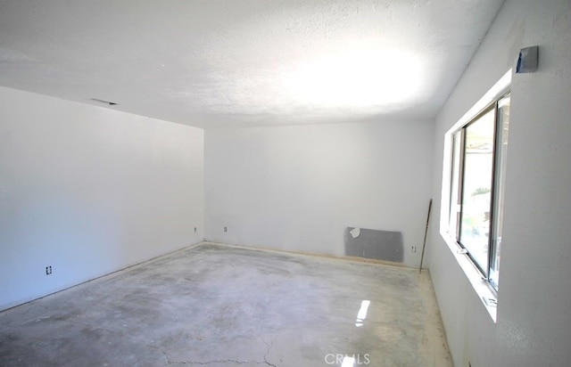 spare room with a textured ceiling