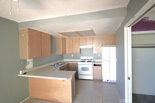 kitchen with a textured ceiling, kitchen peninsula, and white appliances