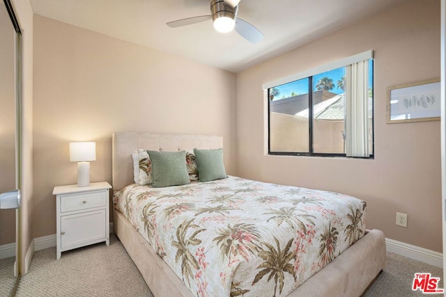 carpeted bedroom with a closet and ceiling fan