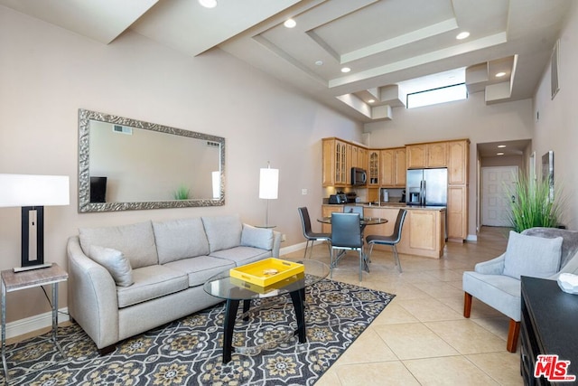 tiled living room with a towering ceiling and a tray ceiling