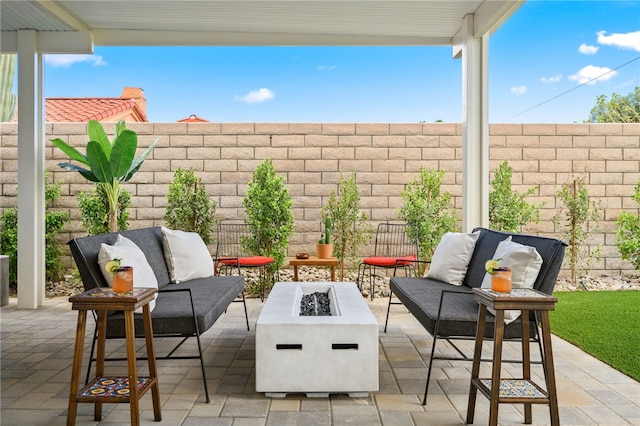 view of patio / terrace with an outdoor living space with a fire pit