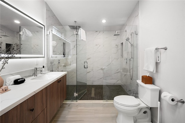 bathroom featuring walk in shower, vanity, and toilet