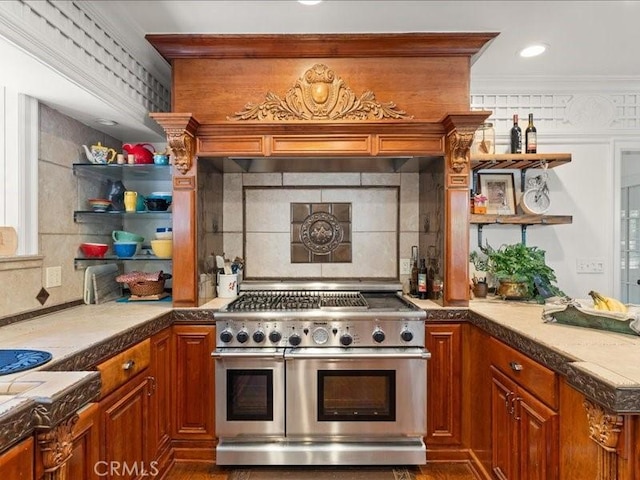 kitchen featuring range with two ovens, crown molding, and backsplash