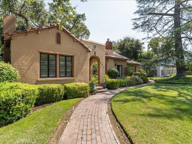 mediterranean / spanish house featuring a front yard