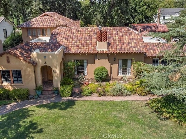 mediterranean / spanish house with a front lawn