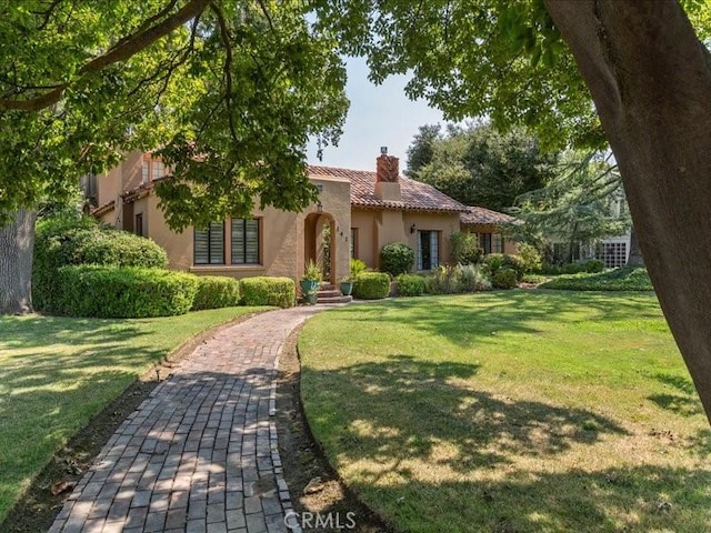 mediterranean / spanish-style house with a front lawn