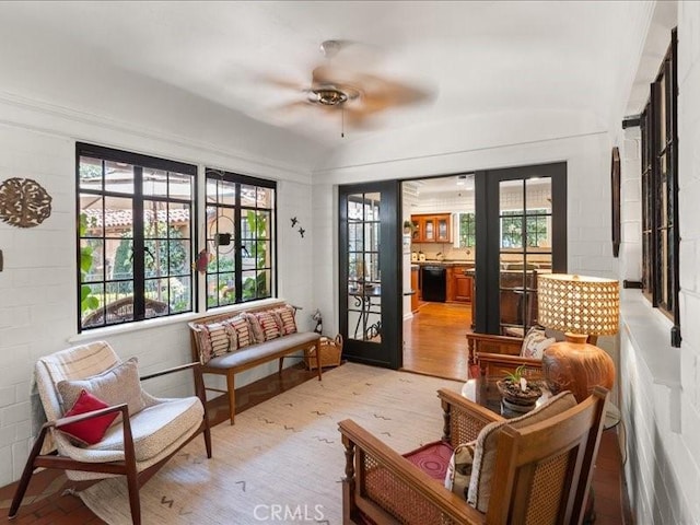 sunroom / solarium featuring ceiling fan