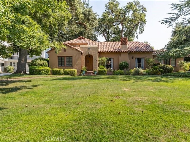 mediterranean / spanish-style house with a front yard