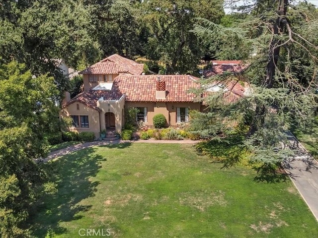 mediterranean / spanish-style home featuring a front yard