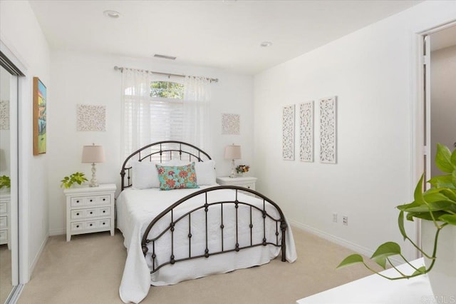 bedroom featuring light colored carpet