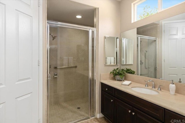 bathroom featuring walk in shower and vanity