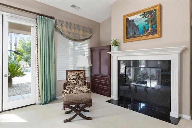 sitting room featuring light colored carpet