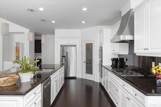 kitchen featuring wall chimney exhaust hood, stainless steel appliances, sink, and white cabinetry