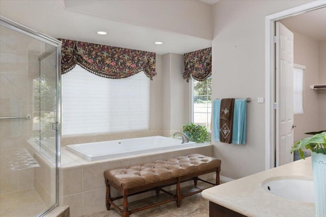 bathroom featuring vanity and shower with separate bathtub