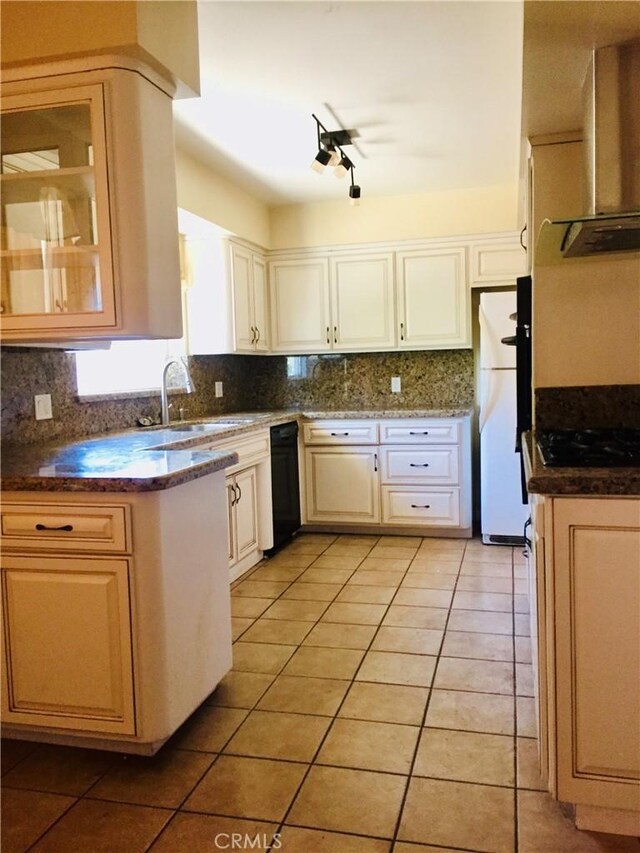 kitchen with sink, range hood, white fridge, decorative backsplash, and light tile patterned floors