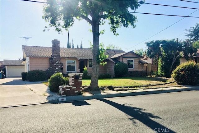 single story home with a garage and a front yard