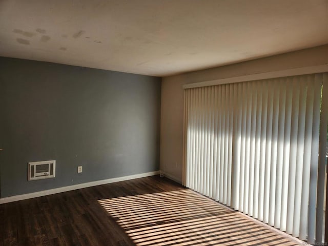 unfurnished room featuring dark wood-type flooring