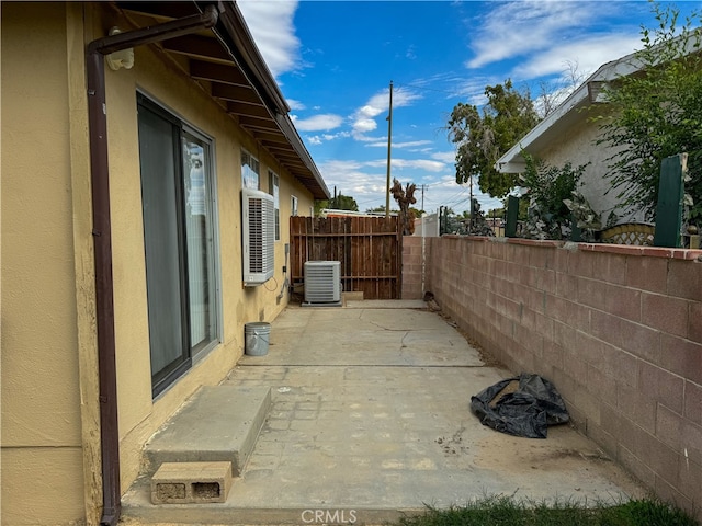 view of property exterior with a patio area and central AC unit