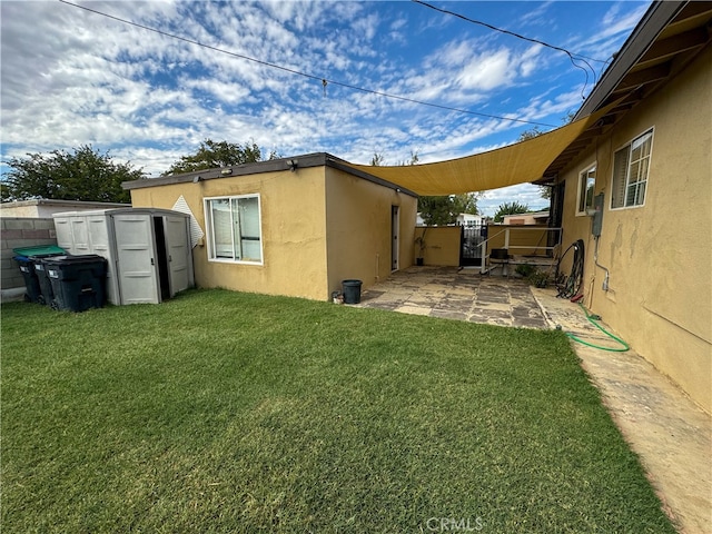 exterior space with a storage shed, a yard, and a patio area