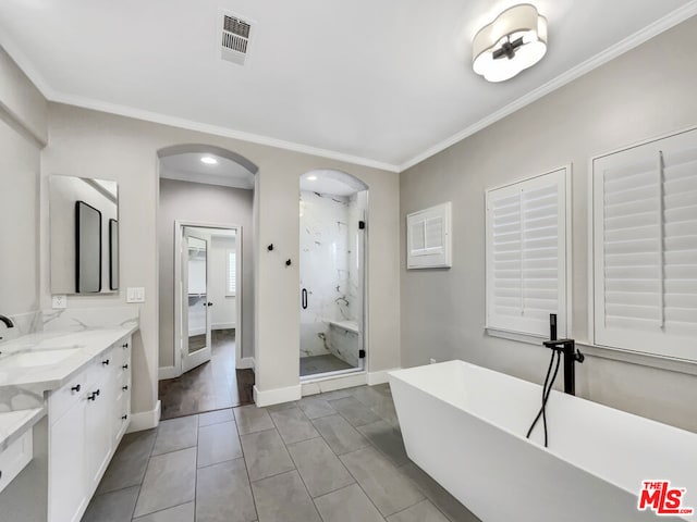 bathroom with tile patterned flooring, vanity, separate shower and tub, and crown molding