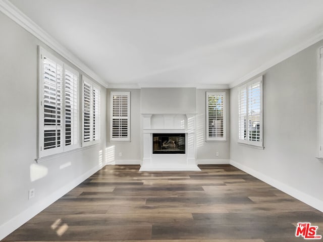 unfurnished living room with crown molding and dark wood-type flooring