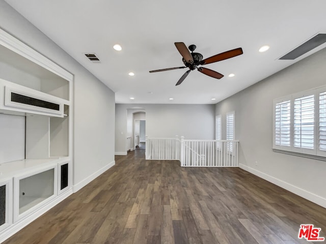 unfurnished living room with ceiling fan and dark hardwood / wood-style flooring