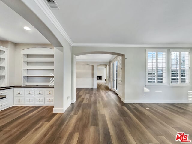 hall featuring dark hardwood / wood-style floors, built in features, and crown molding