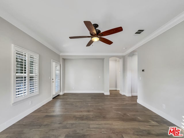 empty room featuring ceiling fan, dark hardwood / wood-style floors, and ornamental molding