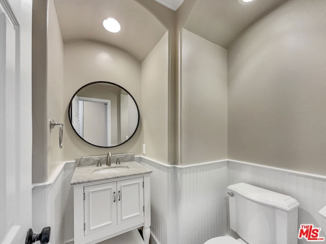 bathroom featuring vanity and toilet