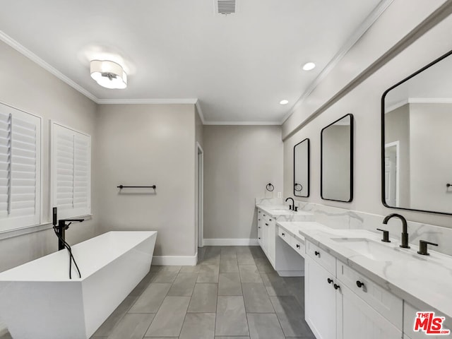 bathroom featuring vanity, a tub to relax in, tile patterned floors, and crown molding