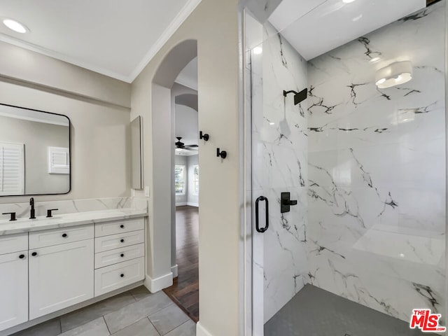 bathroom featuring an enclosed shower, ornamental molding, vanity, ceiling fan, and hardwood / wood-style flooring