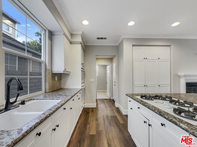 kitchen featuring white cabinets and light stone countertops