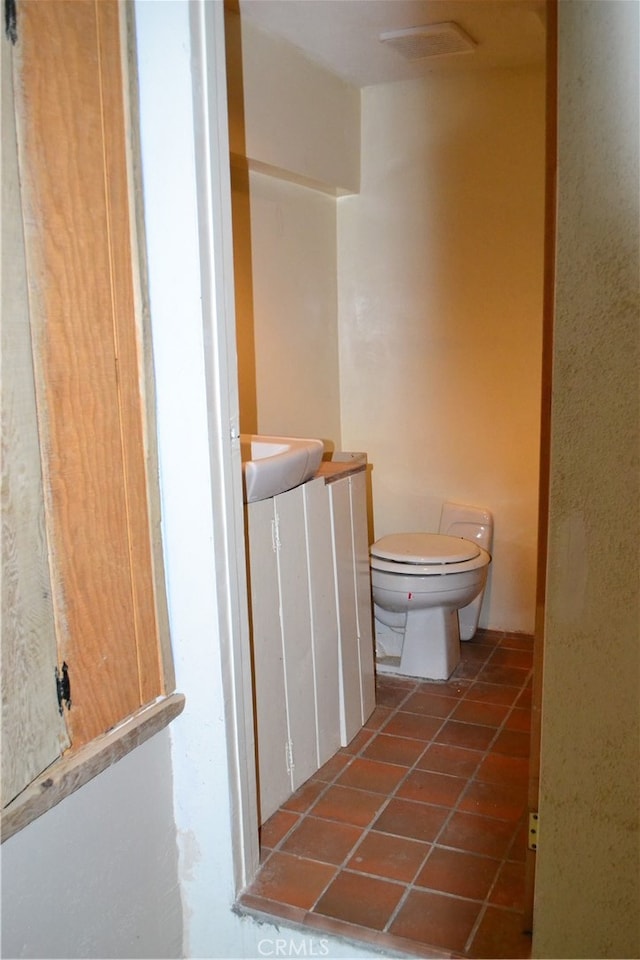 bathroom featuring tile patterned flooring, sink, and toilet