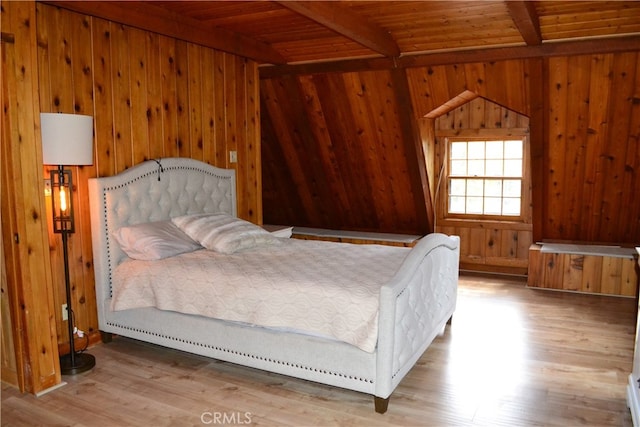 bedroom with wood-type flooring, wood ceiling, and wood walls