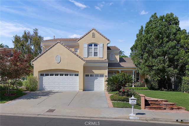 view of front of property featuring a garage and a front lawn