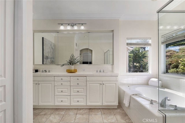 bathroom with vanity, a relaxing tiled tub, ornamental molding, and tile patterned floors