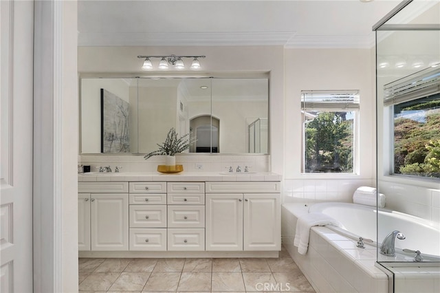 bathroom with crown molding, vanity, and tiled bath