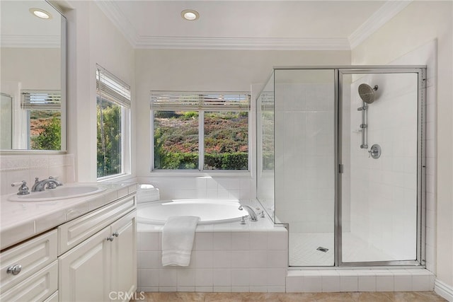 bathroom with ornamental molding, separate shower and tub, and vanity