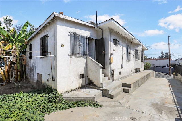 view of side of home featuring a patio area