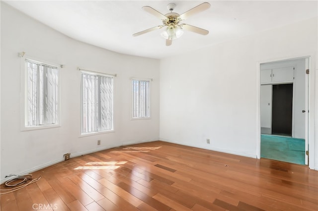 spare room with hardwood / wood-style floors and ceiling fan