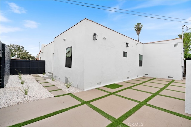 view of side of home with a patio