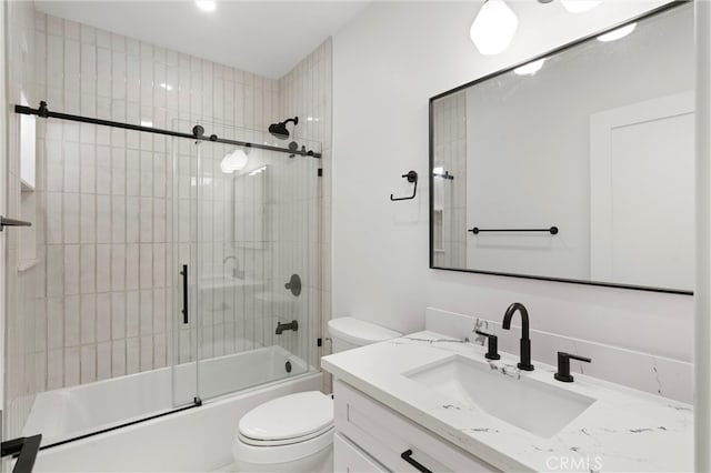 full bathroom featuring enclosed tub / shower combo, vanity, and toilet