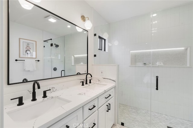 bathroom with walk in shower, vanity, and tile patterned floors