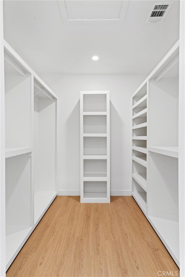 walk in closet featuring hardwood / wood-style floors