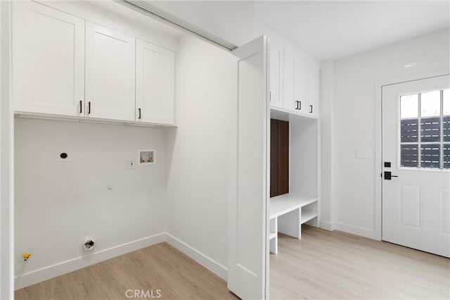 laundry room featuring washer hookup, light hardwood / wood-style floors, cabinets, hookup for a gas dryer, and hookup for an electric dryer