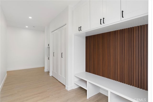 mudroom with light hardwood / wood-style flooring